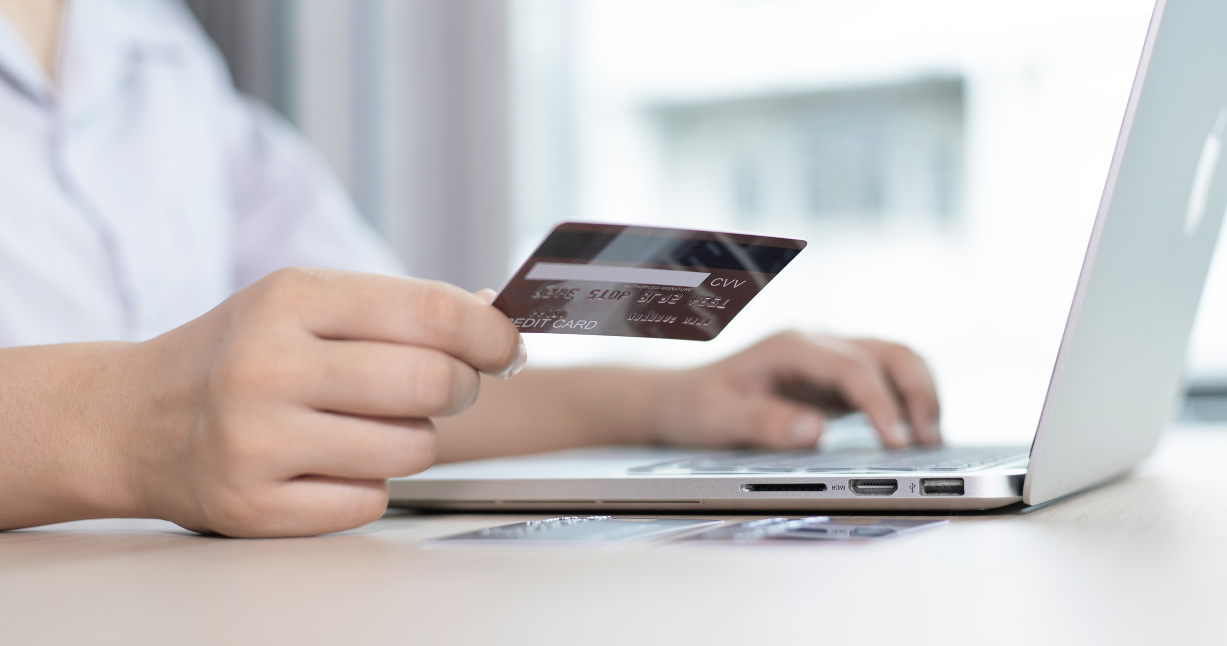 Person Using Credit Card To Purchase Online Orders